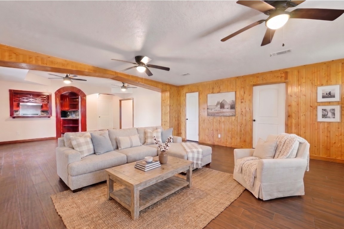 6014 Linda Drive Rosharon, TX 77583 - Photo 5 of 23 The seamless flow between the living and dining spaces is highlighted by natural wood finishes, recessed arched entries, and consistent wide-tile floors.**Virtually staged
