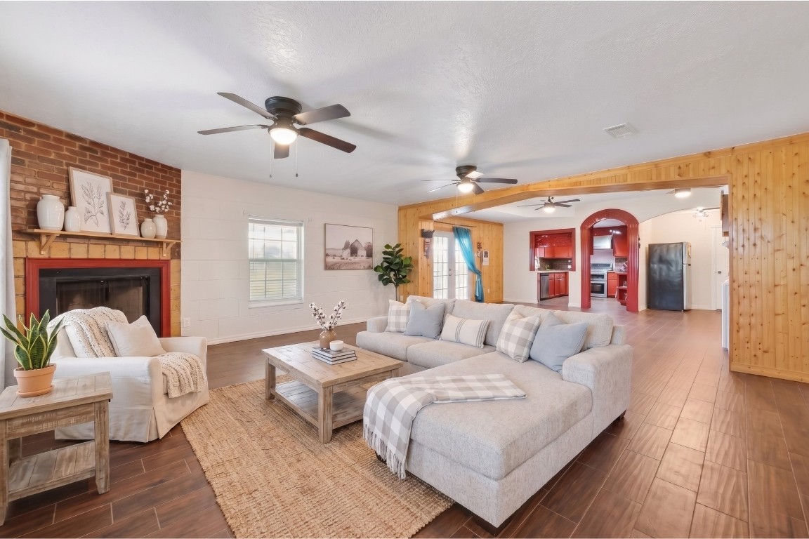 6014 Linda Drive Rosharon, TX 77583 - Photo 6 of 23 A brick-surround fireplace serves as the focal point of the main living room, which is illuminated by natural light from large windows.**Virtually staged