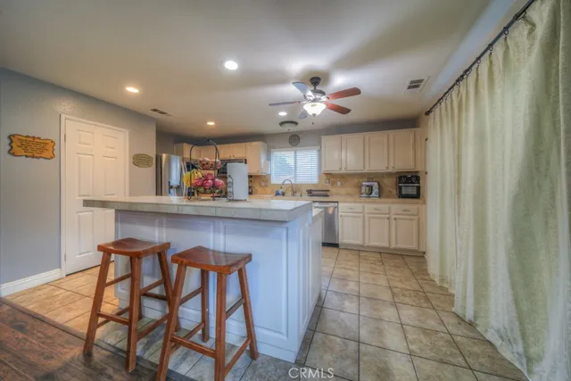 a kitchen with stainless steel appliances granite countertop a stove a sink a microwave and a refrigerator