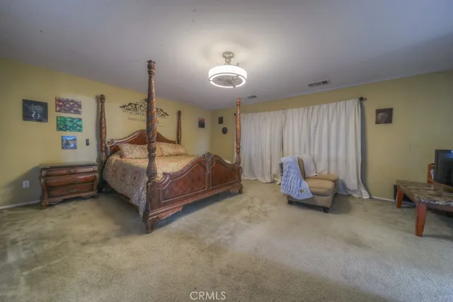 a bedroom with furniture and a chandelier