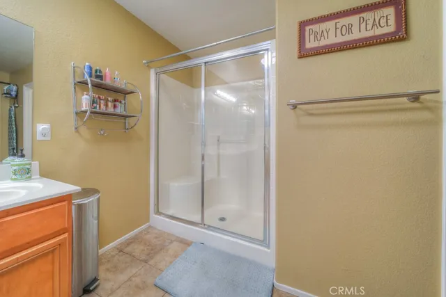 a spacious bathroom with a granite countertop sink a mirror and a bathtub