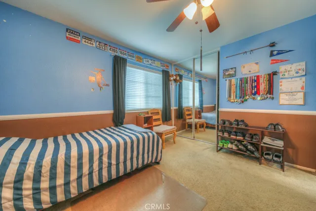 a spacious bedroom with a bed and a chandelier