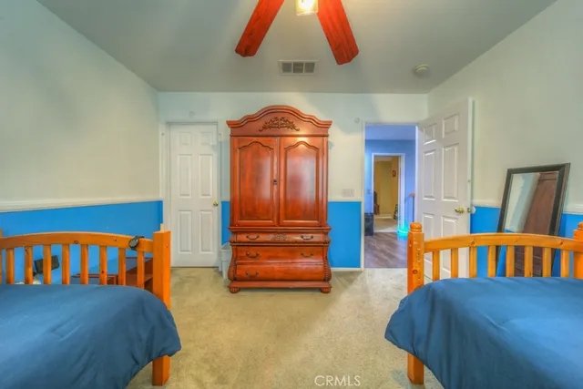 a living room with furniture a rug and a lamp