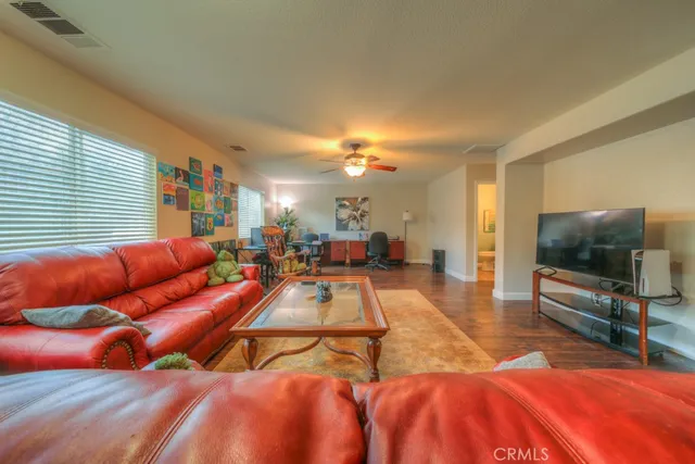 a living room with furniture and a wooden floor