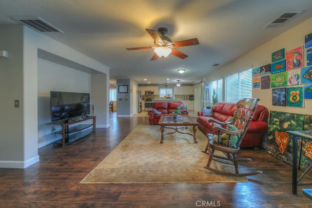 a living room with furniture a flat screen tv and a table
