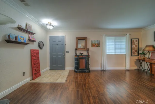 a view of a livingroom with wooden floor and furniture