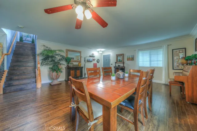 a dining room with furniture and wooden floor