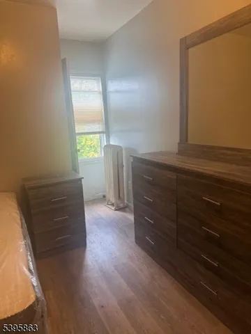 a view of room with window and hardwood floor