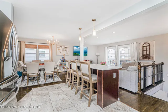 a very nice looking dining room with many windows a table and chairs
