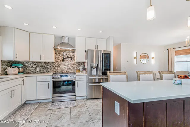 a kitchen with stainless steel appliances kitchen island granite countertop a sink and cabinets
