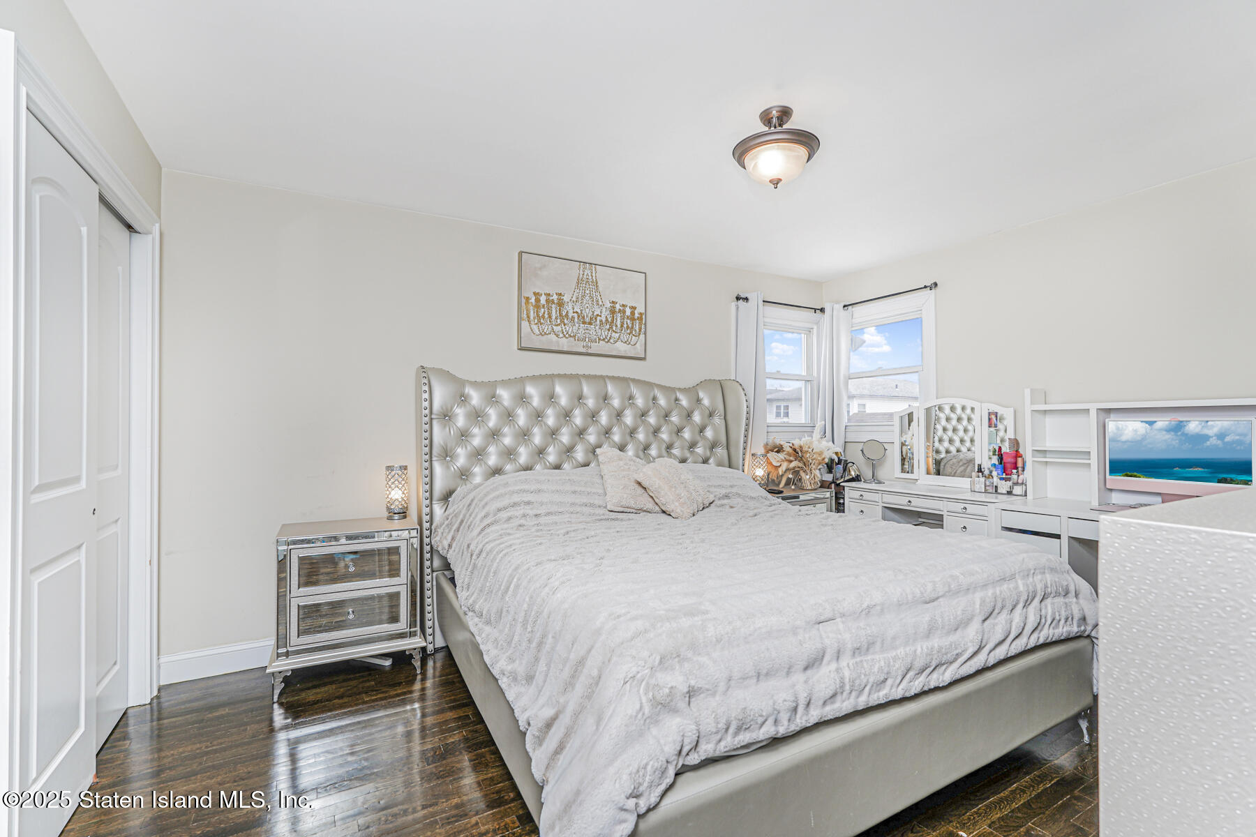 28 Drumgoole Road East Staten Island, NY 10312 - Photo 14 of 28 a bedroom with a bed and a chandelier