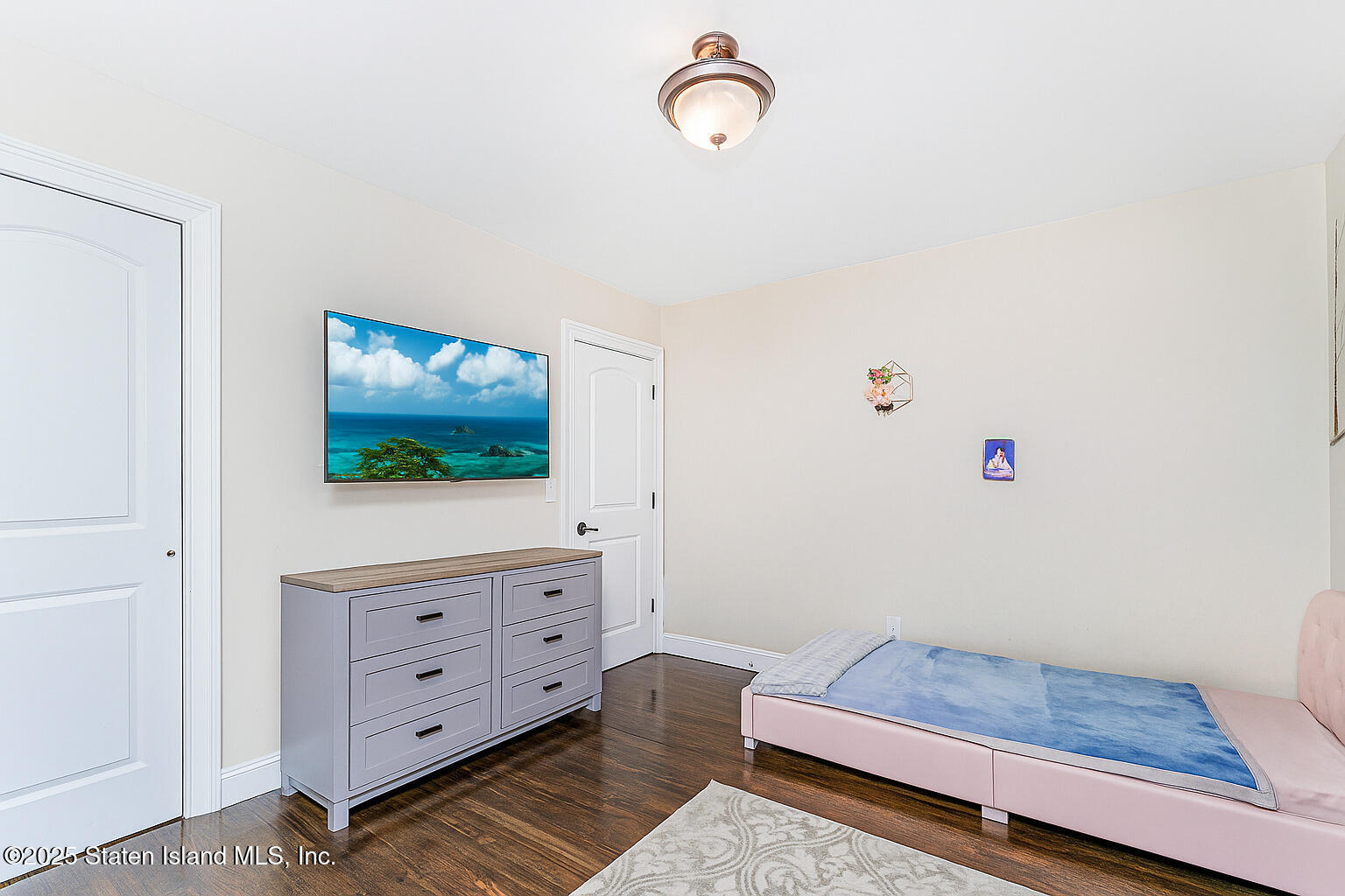 28 Drumgoole Road East Staten Island, NY 10312 - Photo 17 of 28 a living room with furniture and a flat screen tv