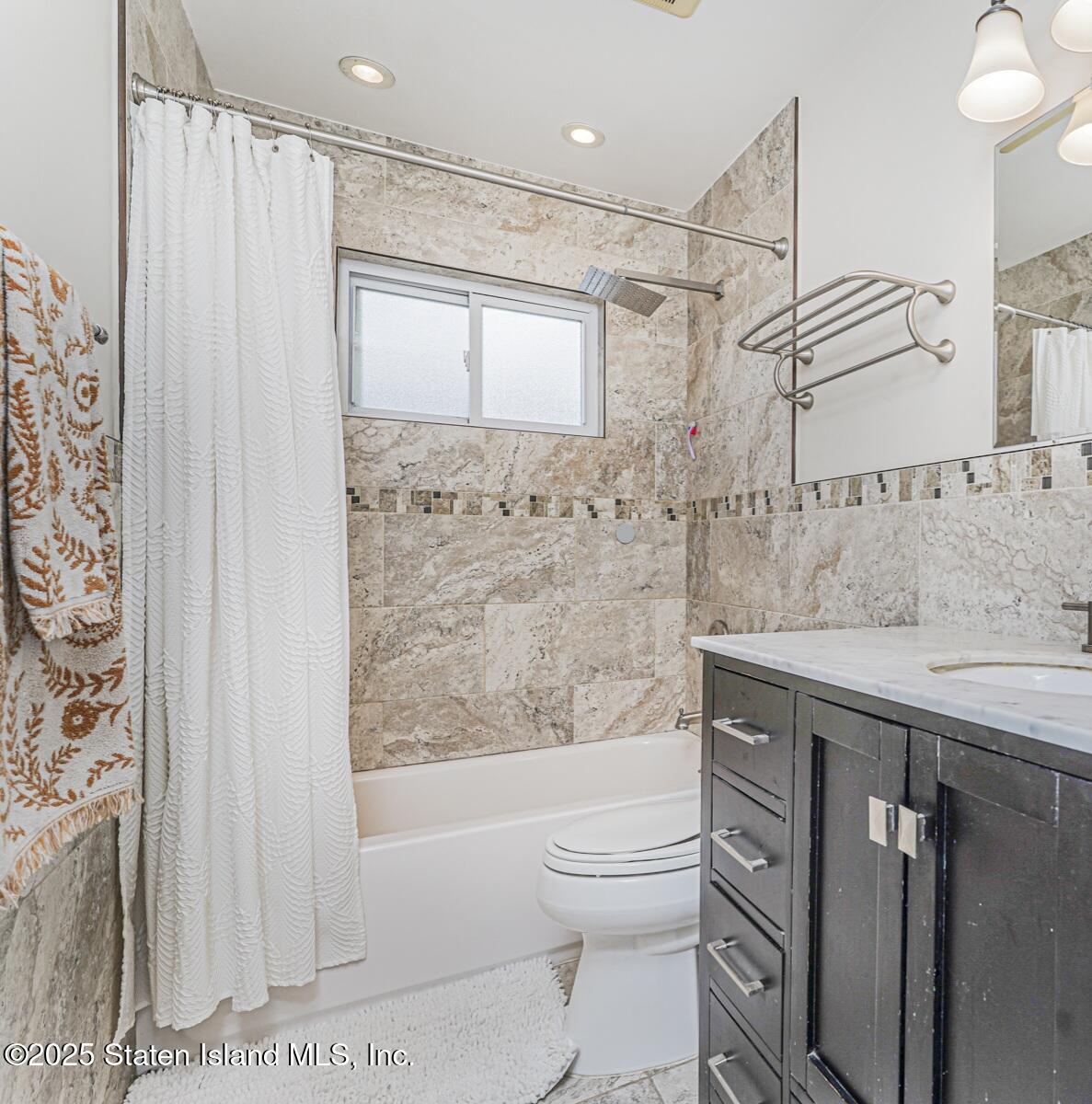 28 Drumgoole Road East Staten Island, NY 10312 - Photo 18 of 28 a bathroom with a granite countertop sink toilet and shower