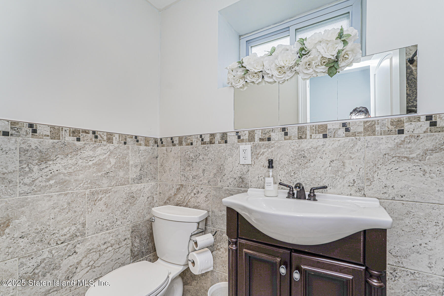 28 Drumgoole Road East Staten Island, NY 10312 - Photo 19 of 28 a bathroom with a sink a toilet and a mirror