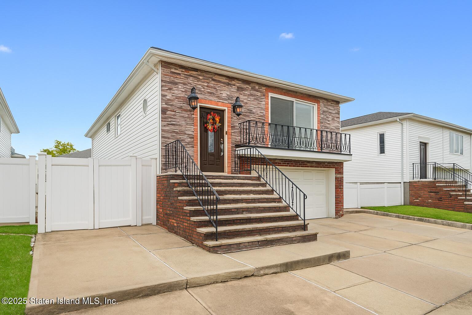 28 Drumgoole Road East Staten Island, NY 10312 - Photo 2 of 28 a front view of a house with a garage