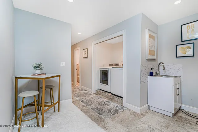 a view of kitchen with sink microwave and cabinets