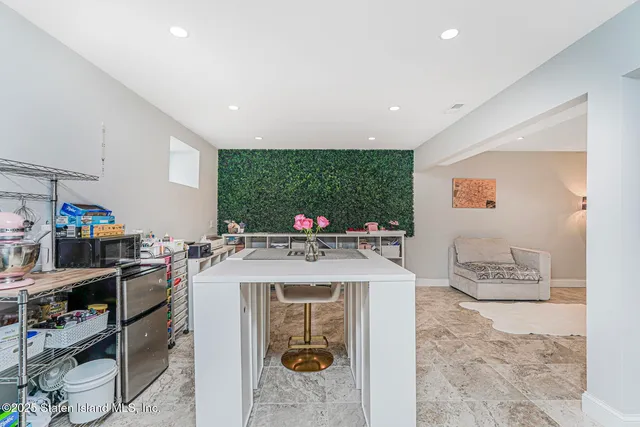 a view of a kitchen with kitchen island granite countertop lots of counter top space