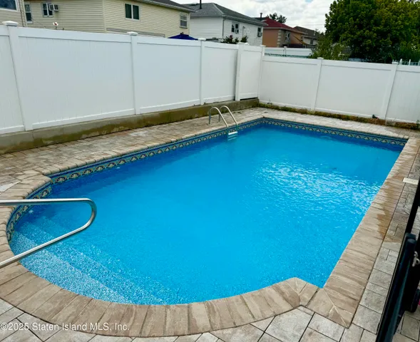 a view of a backyard with swimming pool