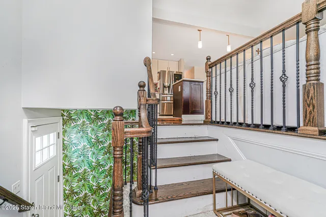 a view of entryway and hall with wooden floor