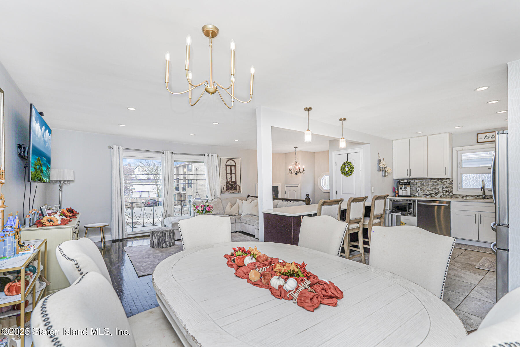 28 Drumgoole Road East Staten Island, NY 10312 - Photo 7 of 28 a living room with furniture a chandelier and kitchen view