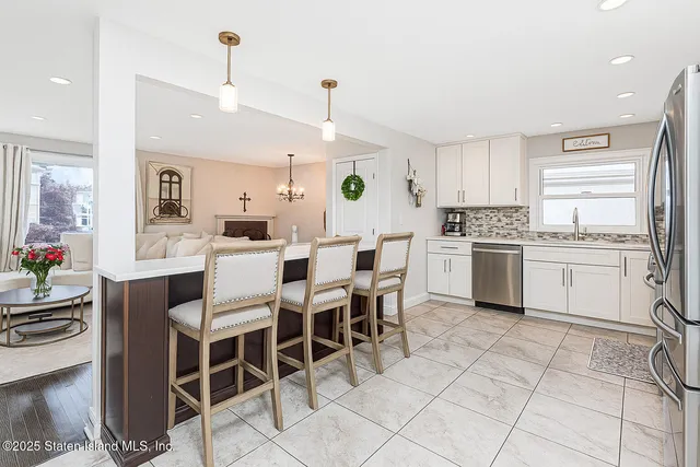 a kitchen with cabinets and chairs