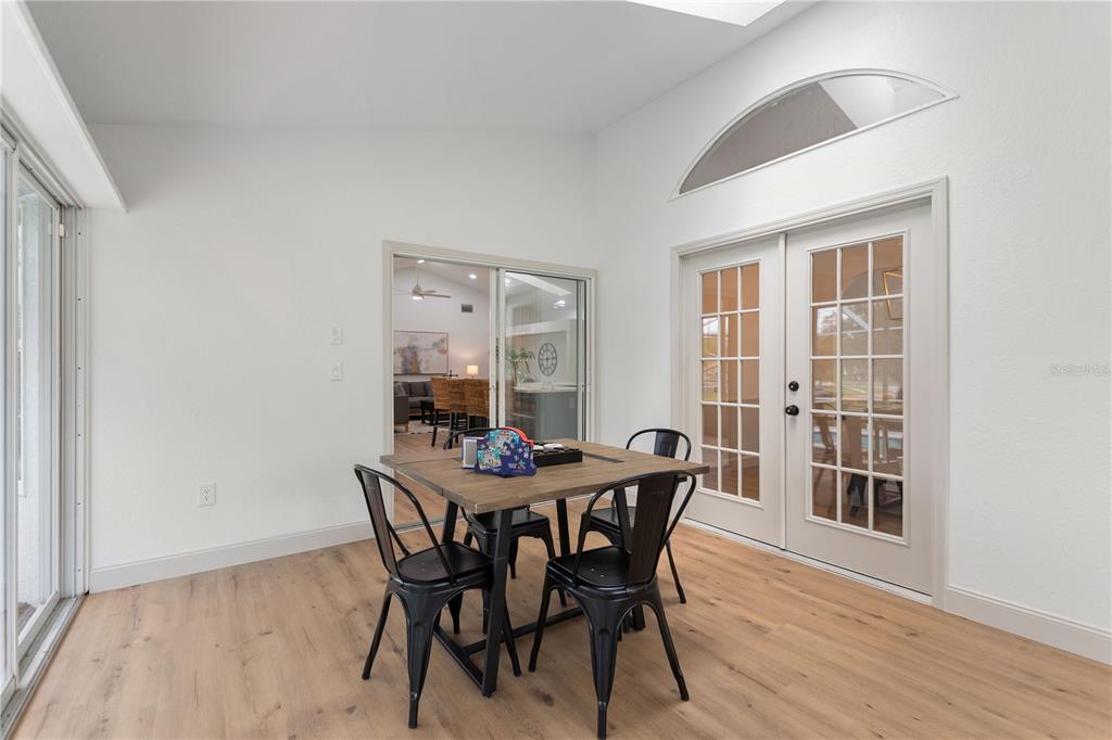 419 Silas Court Spring Hill, FL 34609 - Photo 35 of 56 a view of a dining room with furniture and wooden floor