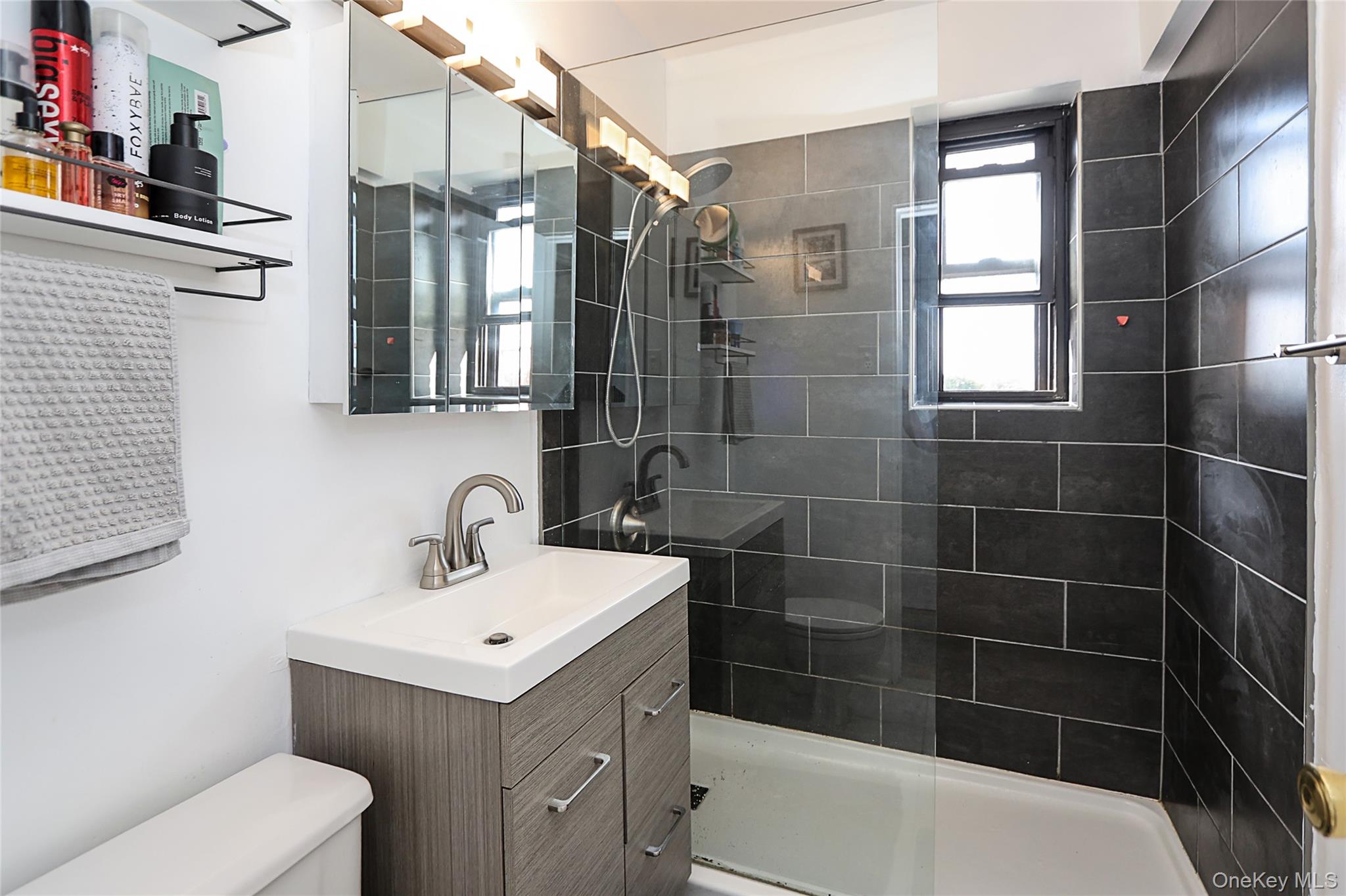 147-10 84th Road, Unit 6K Queens, NY 11435 - Photo 18 of 21 Bathroom with vanity and a shower stall