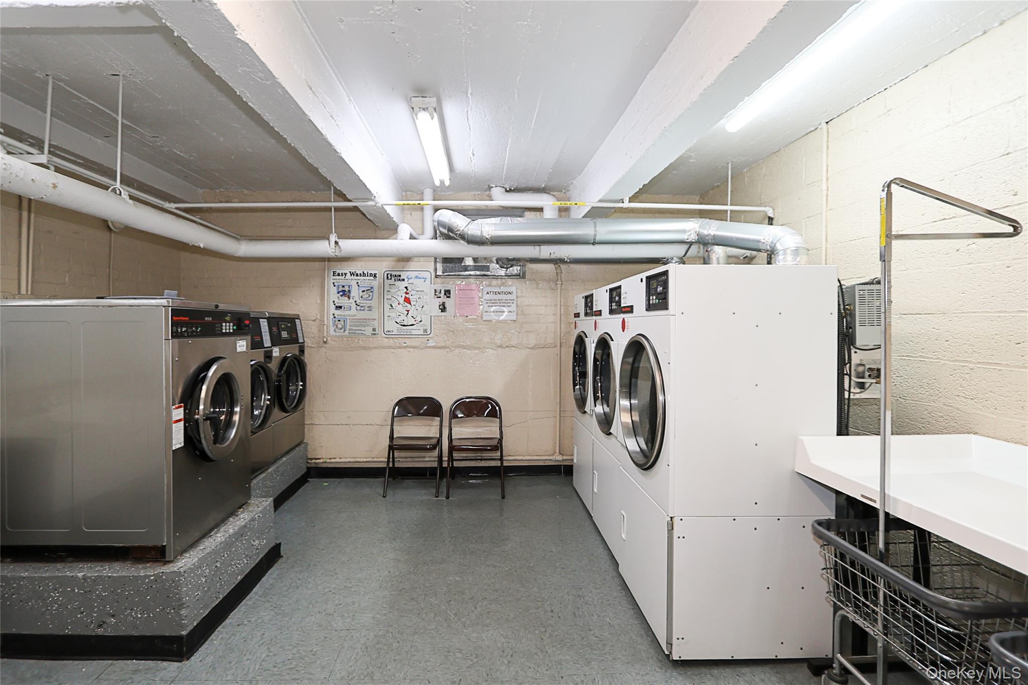 147-10 84th Road, Unit 6K Queens, NY 11435 - Photo 19 of 21 Community laundry room with tile patterned floors and washing machine and clothes dryer
