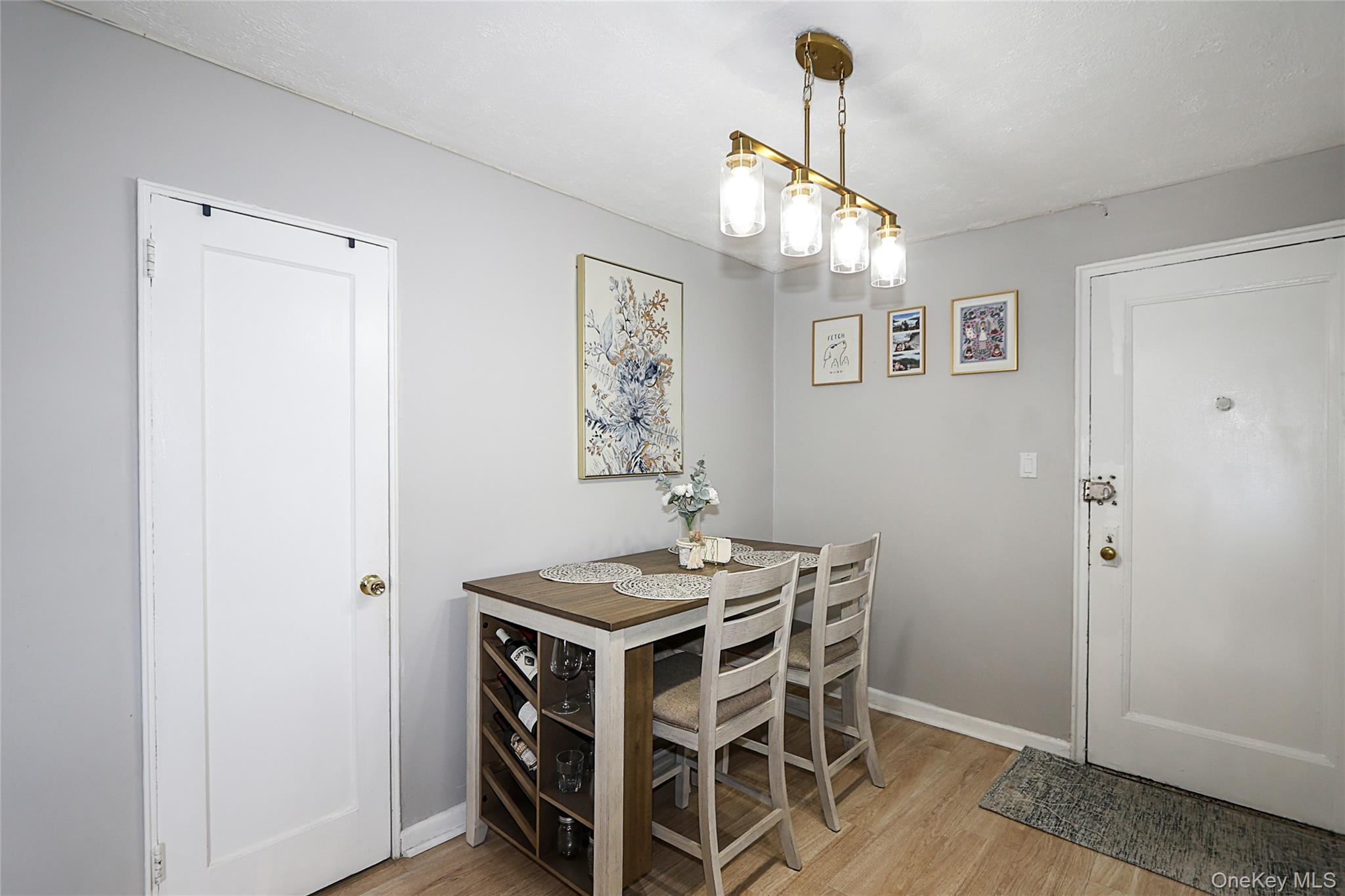 147-10 84th Road, Unit 6K Queens, NY 11435 - Photo 4 of 21 Dining space with light wood-style flooring and baseboards