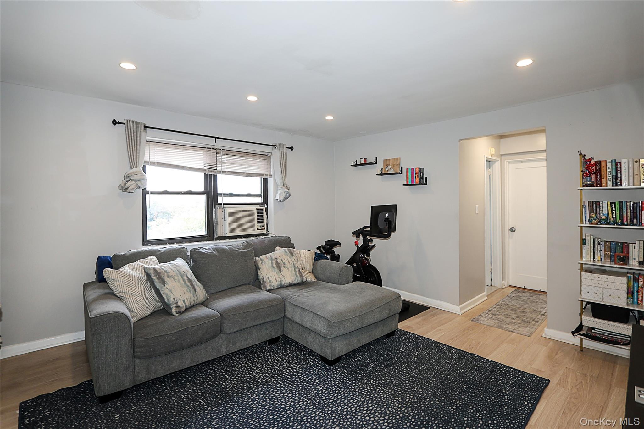 147-10 84th Road, Unit 6K Queens, NY 11435 - Photo 9 of 21 Living room with recessed lighting and light wood-style floors