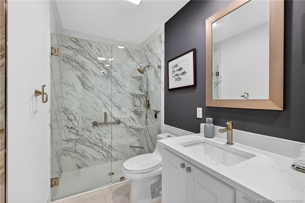 1035 Southwest Tamarrow Place Stuart, FL 34997 - Photo 21 of 46 Updated bathroom with frameless shower
