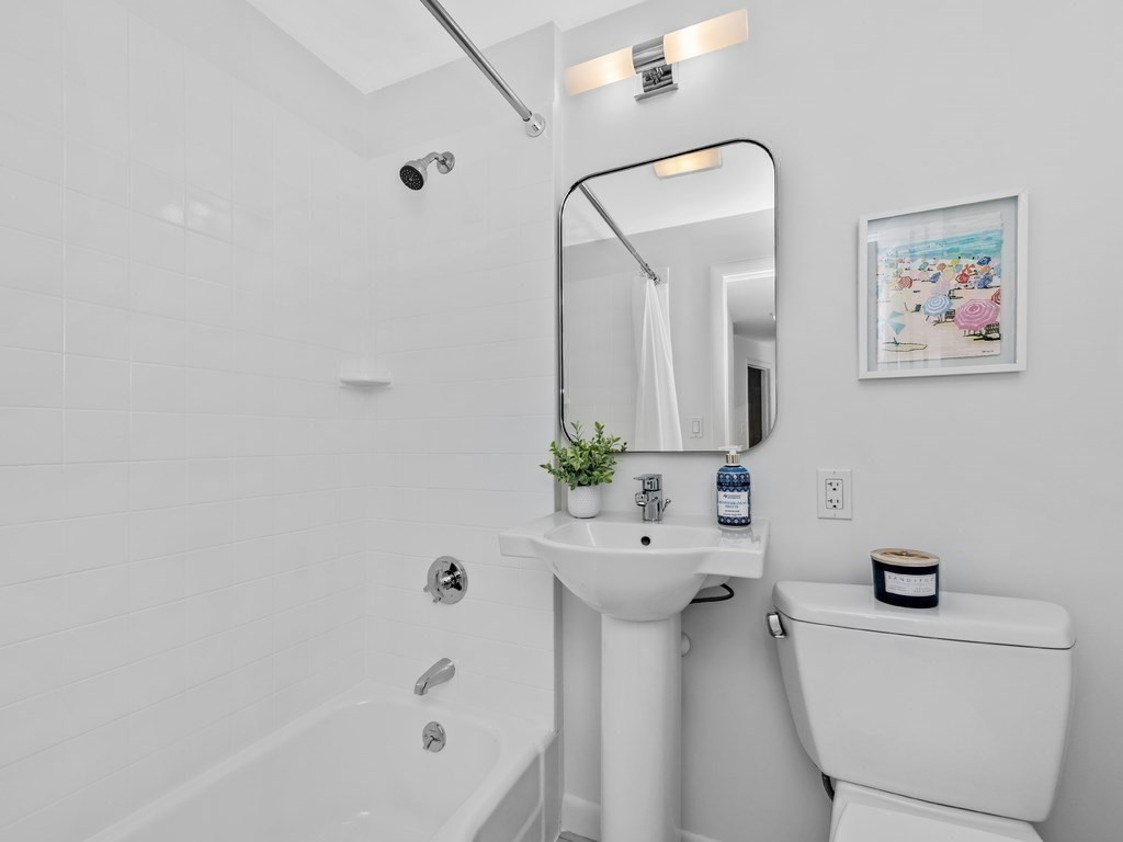 18 R Polk Street Boston, MA 02129 - Photo 14 of 19 a bathroom with a sink a toilet and shower
