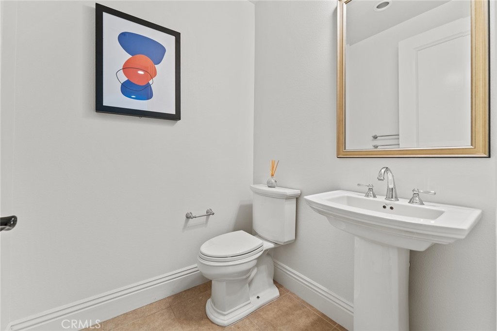 115 Mustard Irvine, CA 92618 - Photo 22 of 74 a bathroom with a toilet sink and mirror