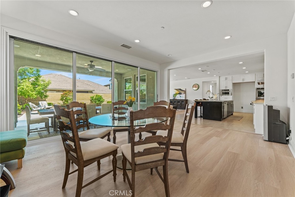 115 Mustard Irvine, CA 92618 - Photo 26 of 74 a dining room with furniture and a floor to ceiling window