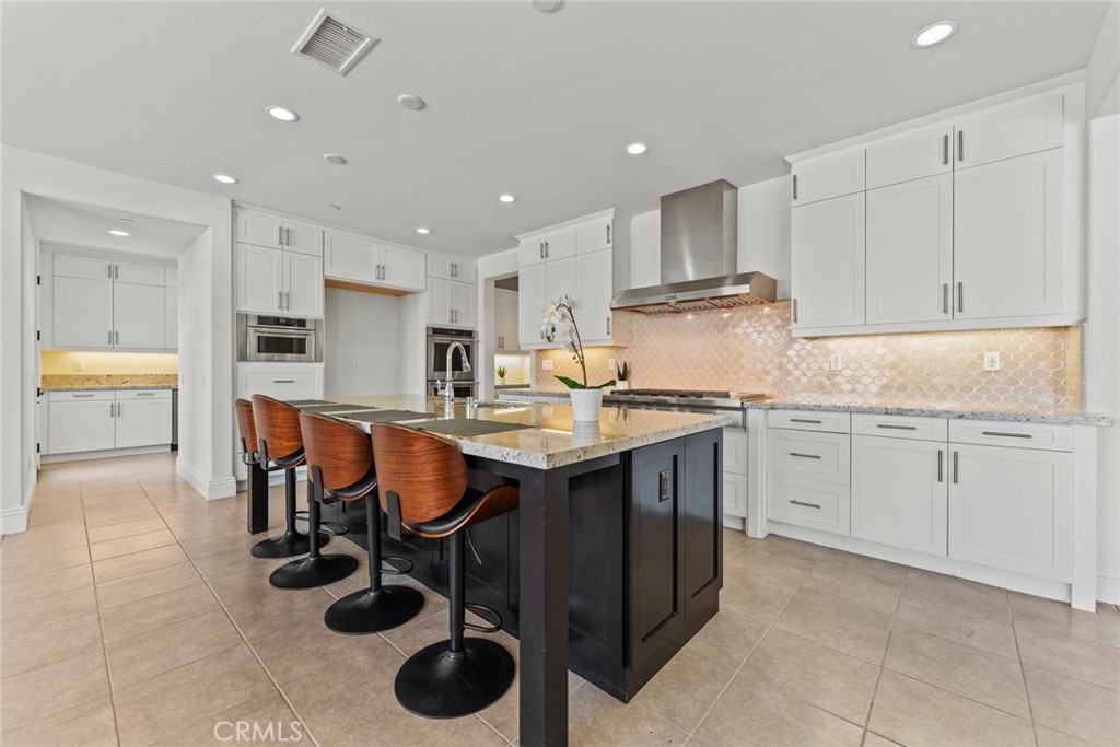 115 Mustard Irvine, CA 92618 - Photo 27 of 74 a kitchen with stainless steel appliances granite countertop a table chairs sink and cabinets