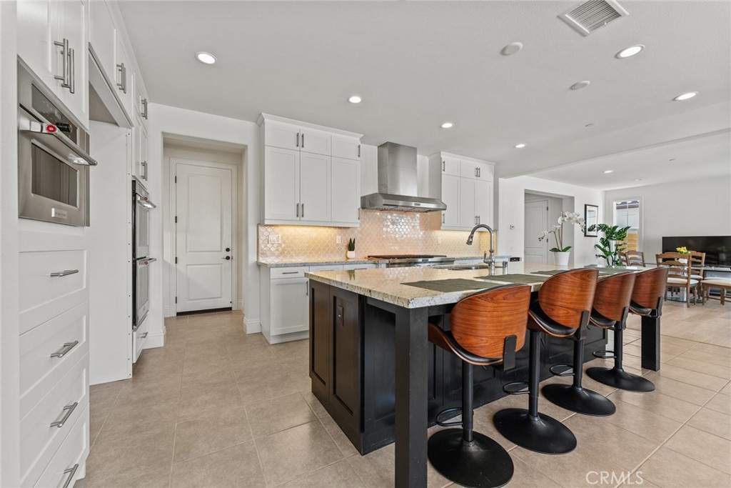 115 Mustard Irvine, CA 92618 - Photo 28 of 74 a kitchen with stainless steel appliances granite countertop a sink a stove a refrigerator and chairs