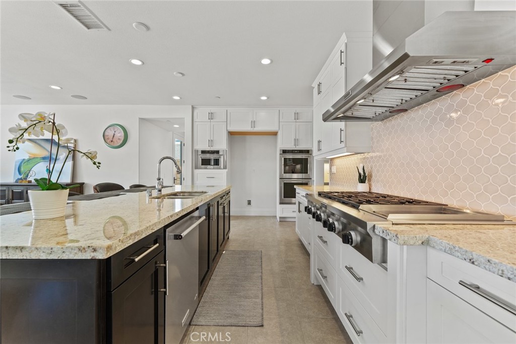 115 Mustard Irvine, CA 92618 - Photo 30 of 74 a kitchen with stainless steel appliances granite countertop a sink stove and refrigerator