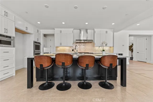 a living room with furniture and a view of kitchen