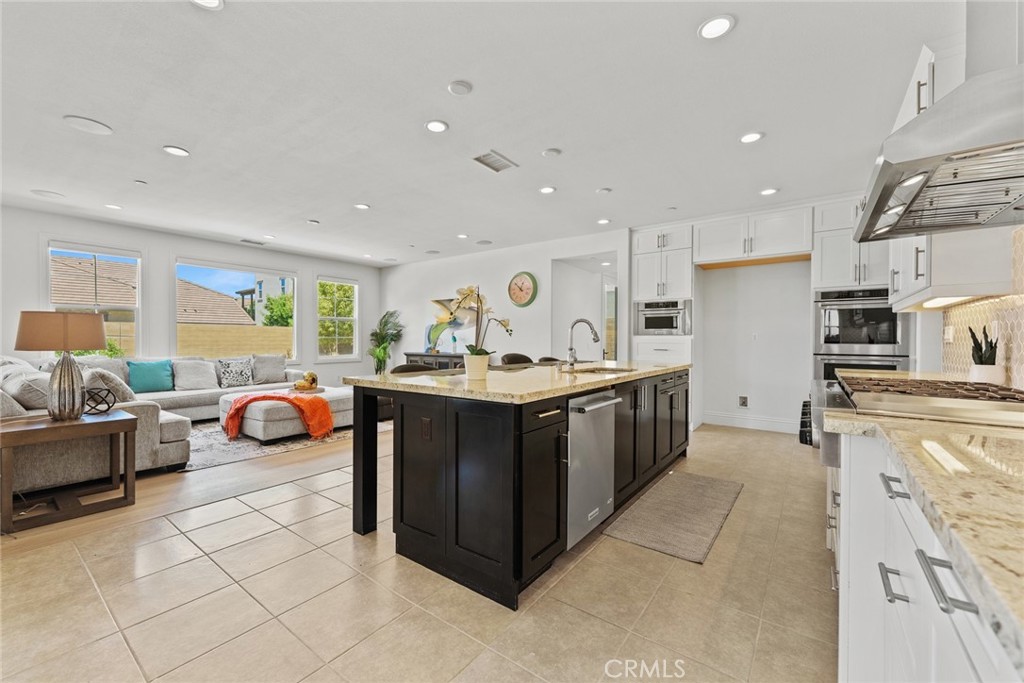 115 Mustard Irvine, CA 92618 - Photo 40 of 74 a kitchen with stainless steel appliances granite countertop a stove and a sink
