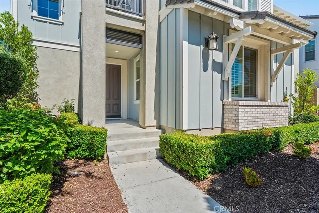 a view of a brick house with potted plants