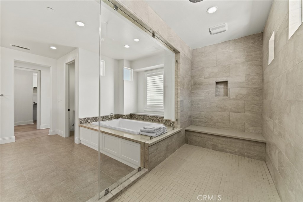 115 Mustard Irvine, CA 92618 - Photo 59 of 74 a bathroom with a granite countertop sink a toilet a mirror and shower