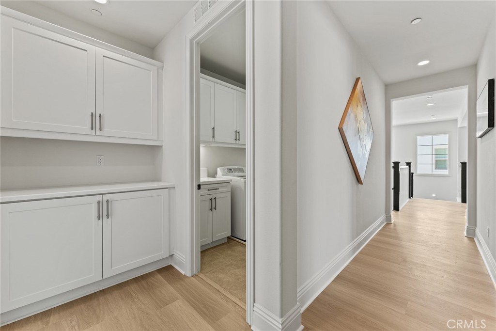 115 Mustard Irvine, CA 92618 - Photo 67 of 74 a view of a hallway with wooden floor and staircase