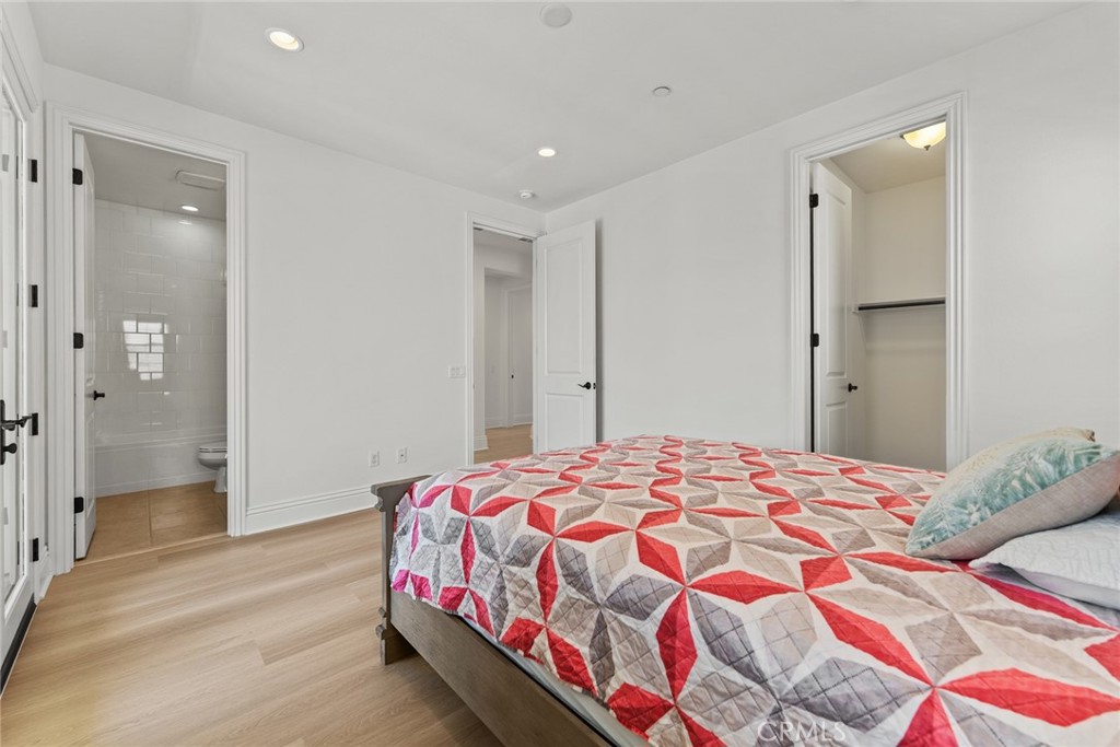 115 Mustard Irvine, CA 92618 - Photo 70 of 74 a bedroom with a bed and a mirror