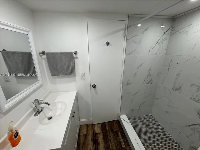 a bathroom with a sink and a shower