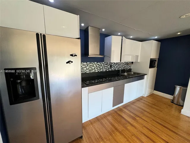 a kitchen with stainless steel appliances a refrigerator and a sink