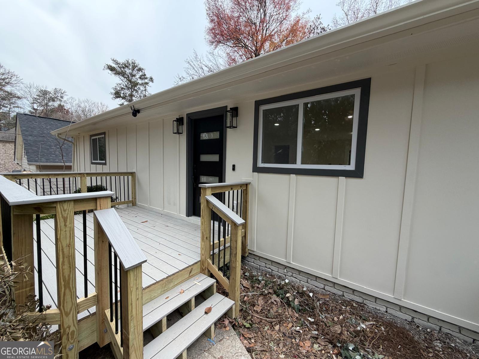 42 West Belle Isle Road Northeast Sandy Springs, GA 30342 - Photo 2 of 5 a view of a house with wooden floor roof and furniture
