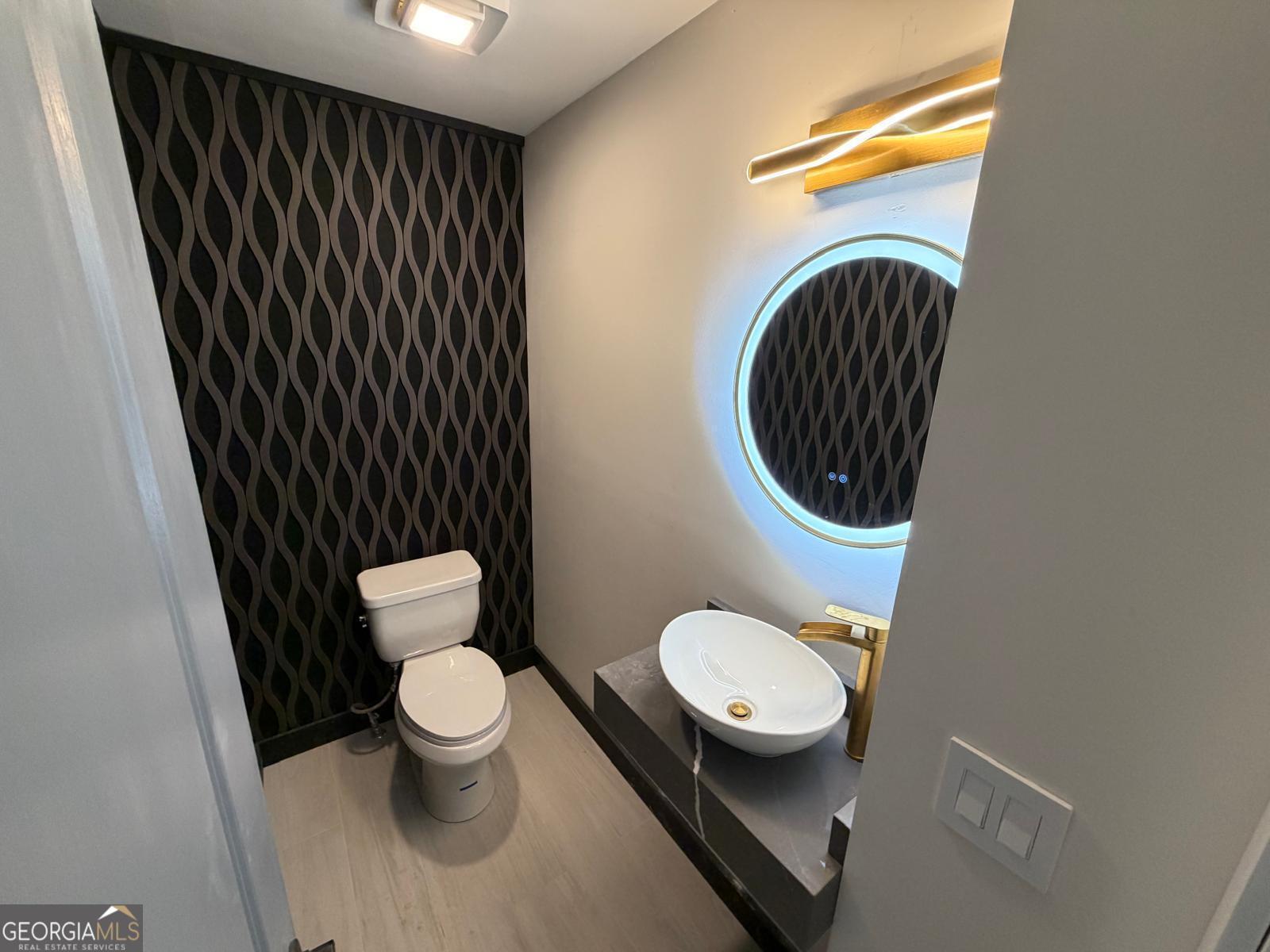 42 West Belle Isle Road Northeast Sandy Springs, GA 30342 - Photo 3 of 5 a bathroom with a toilet and a sink