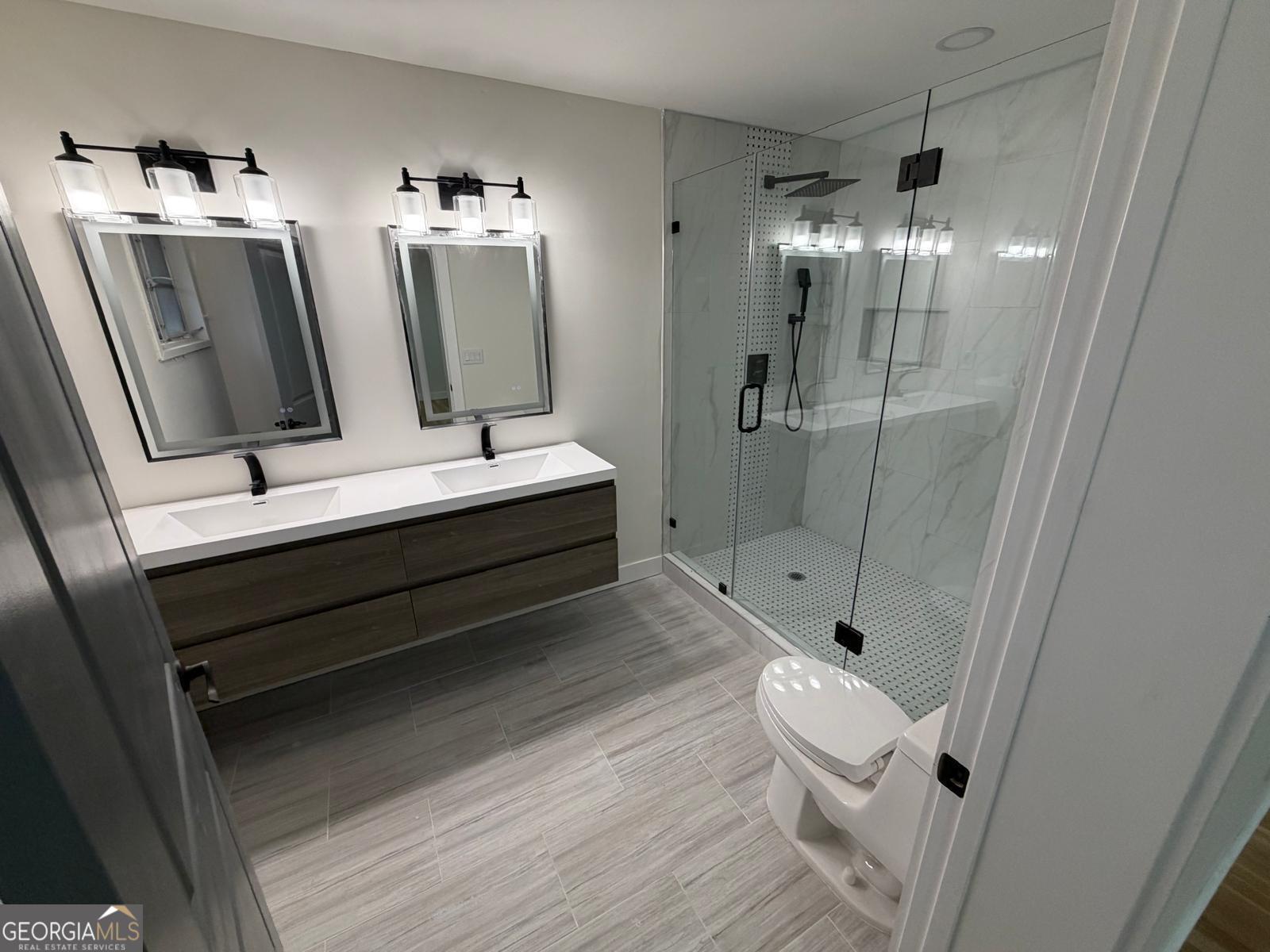 42 West Belle Isle Road Northeast Sandy Springs, GA 30342 - Photo 4 of 5 a bathroom with a double vanity sink toilet and shower