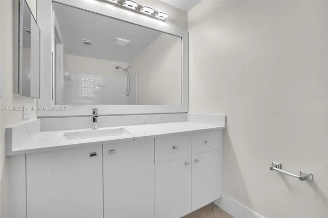 a bathroom with a sink and a mirror