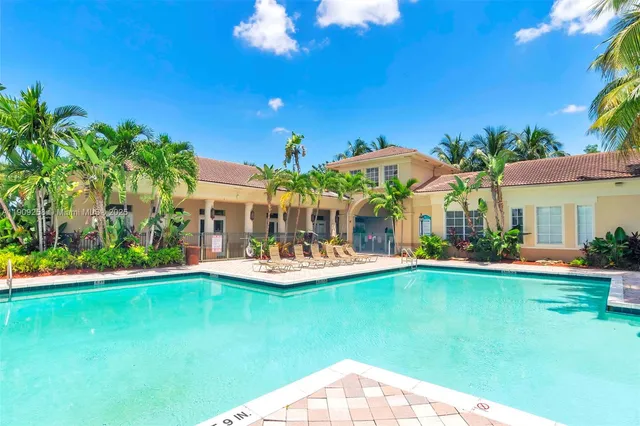 a view of a house with swimming pool garden and patio